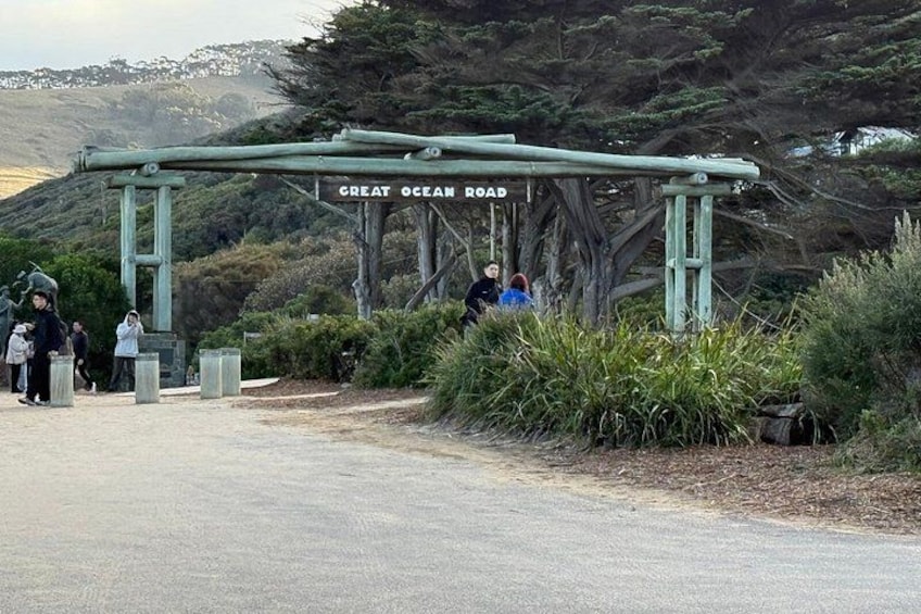 En skylt med texten ”Great Ocean Road”, och människor som promenerar i närheten. 2