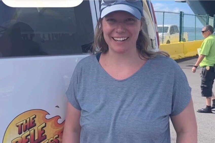A person standing in front of a vehicle with a logo that includes flames and the text 'THE BELLE.' 5