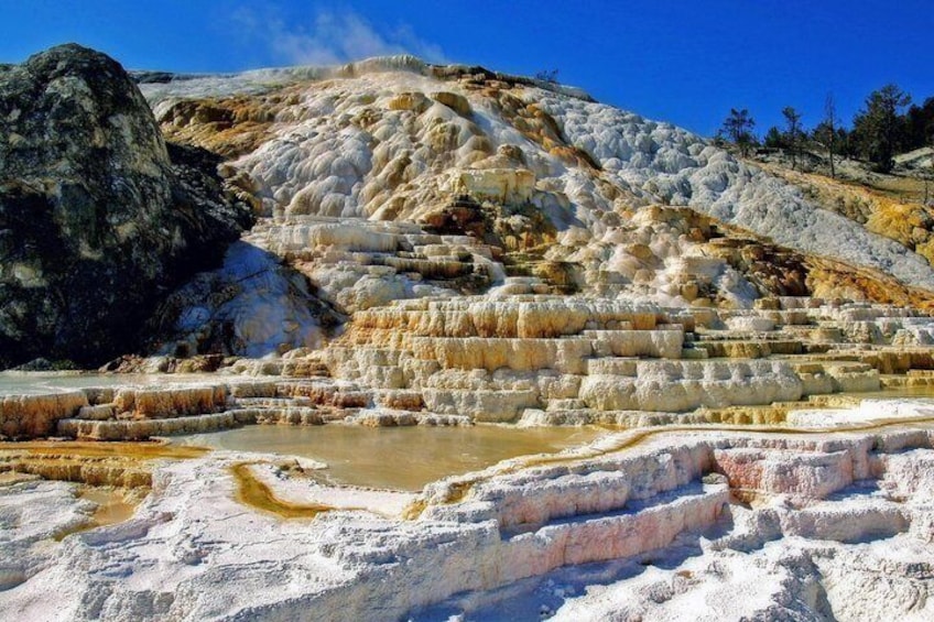 Terraced mineral formations with pools of water at the base. 1