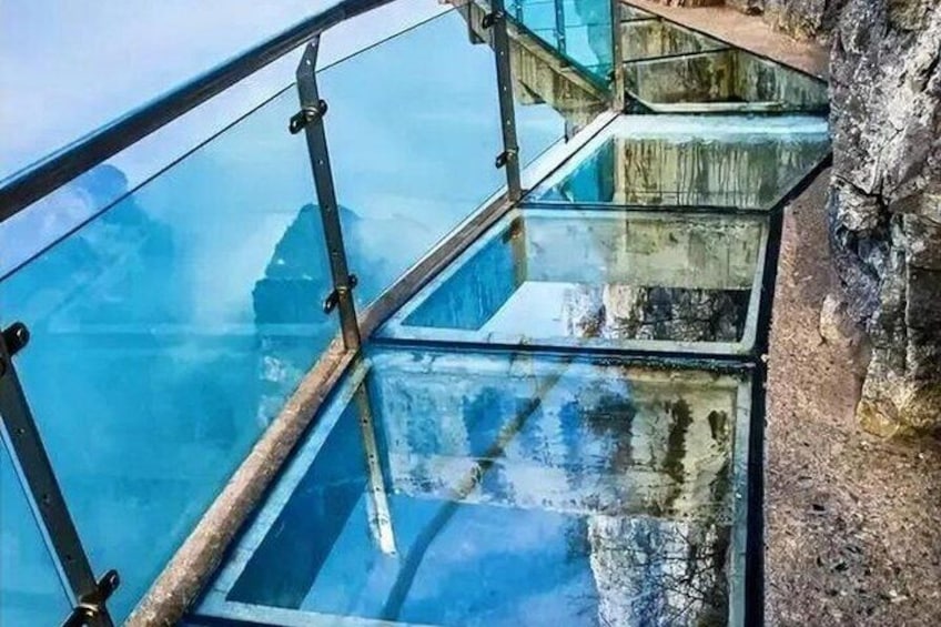 A glass bridge with metal railings. 3