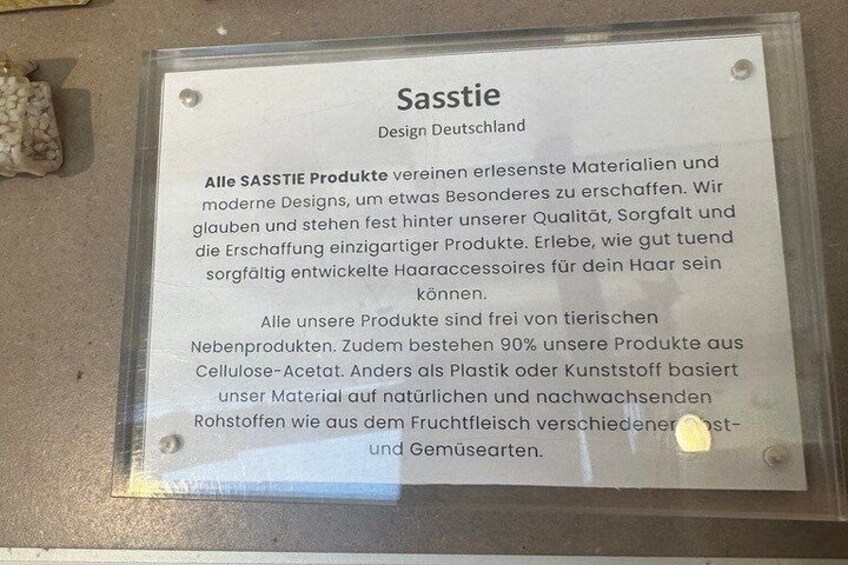A sign with text in German, mounted on a wall. 2
