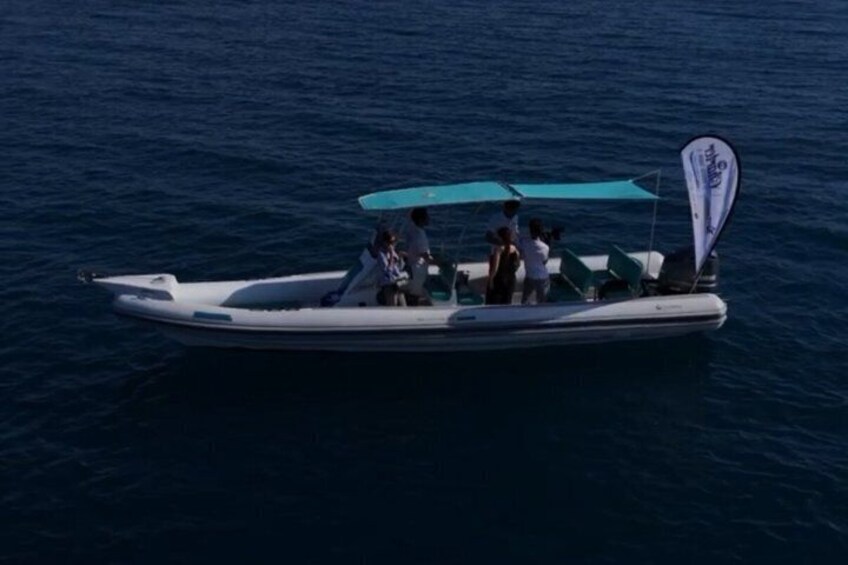 A small boat with a canopy and passengers on a calm sea. 3