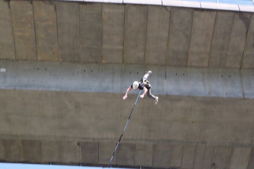 A person bungee jumping from a bridge. 2