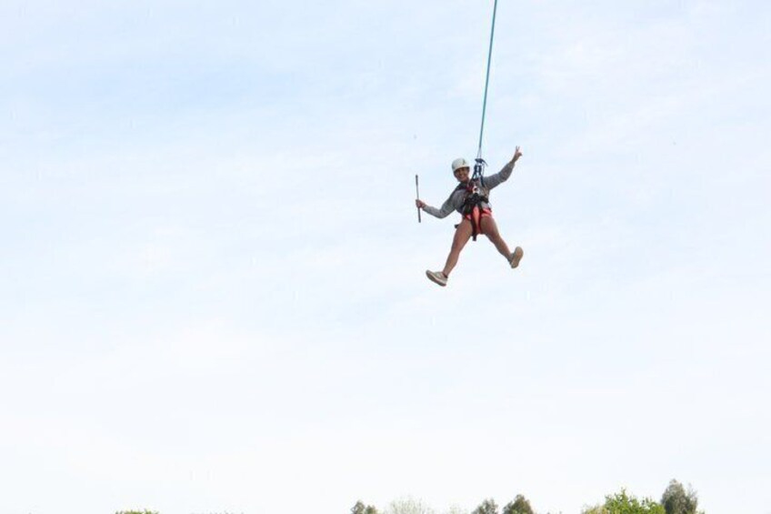 A person ziplining through the air with a blue line. 3