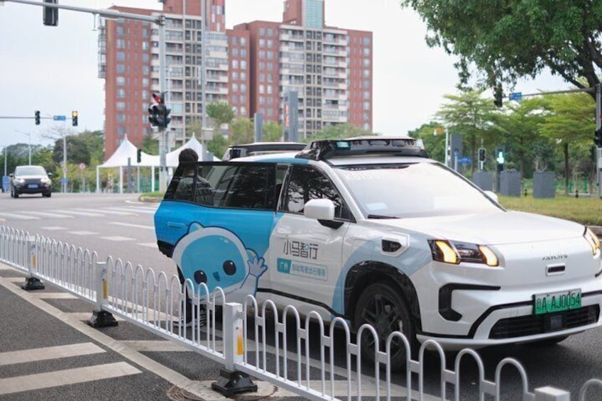 A white car with blue accents and cartoon character decals parked on the side of a road. 5