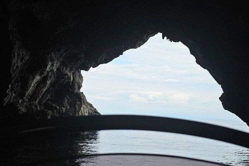 A cave opening with a view of the sea and sky. 2