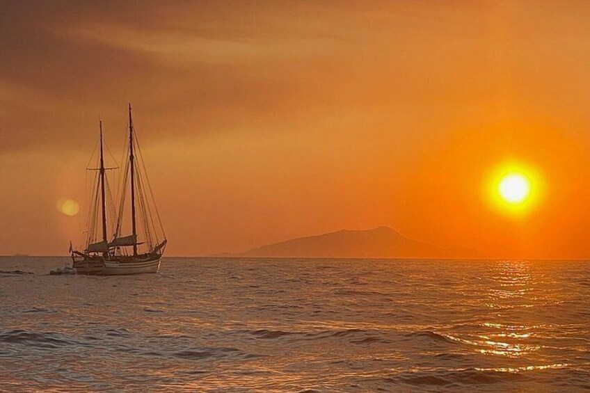A sailboat on calm waters during sunset with a warm glow. 4