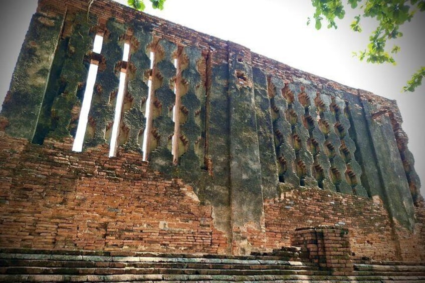 Ancient brick ruins with vertical columns and a partially intact wall. 4