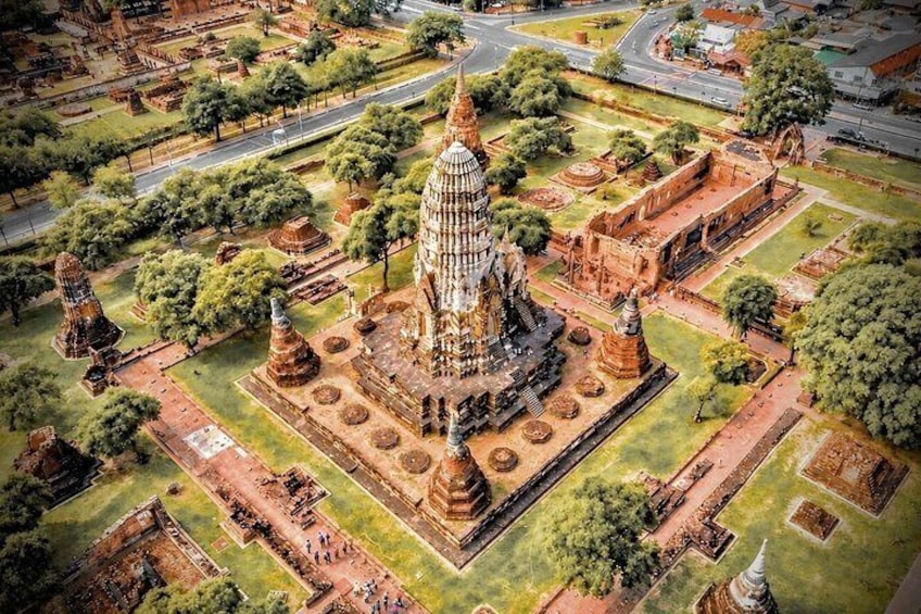 An ancient temple complex with a central stupa, surrounded by smaller structures and pathways. 1