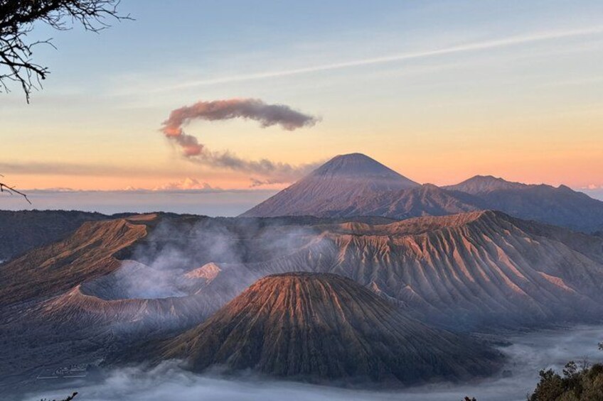 A volcanic landscape with a prominent volcano and layered ridges. 1
