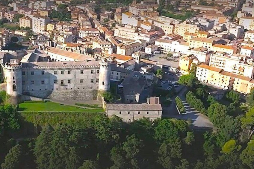 A historic castle surrounded by a dense urban area with traditional buildings. 1