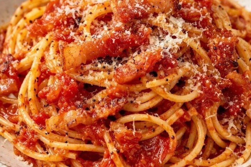 A close-up of spaghetti with tomato sauce and grated cheese. 2