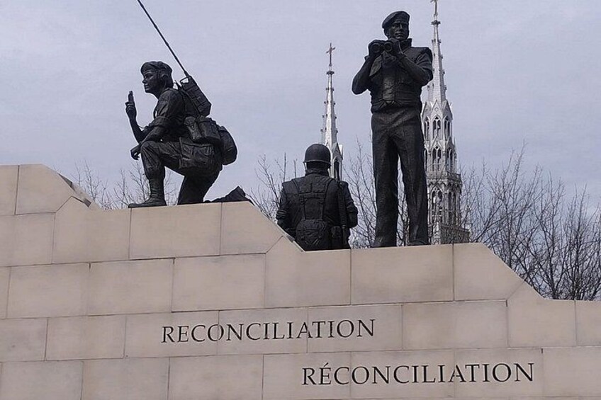 A memorial with statues of soldiers and the word 'RECONCILIATION' on the base. 2
