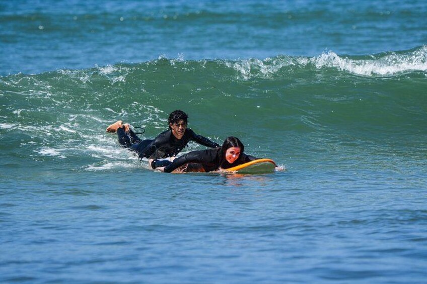 Two people surfing on a wave in the ocean. 4