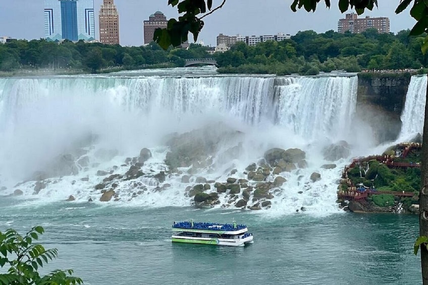 A large waterfall with a boat in the foreground. 5