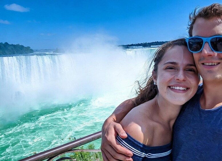 A couple embracing with a waterfall in the background. 1