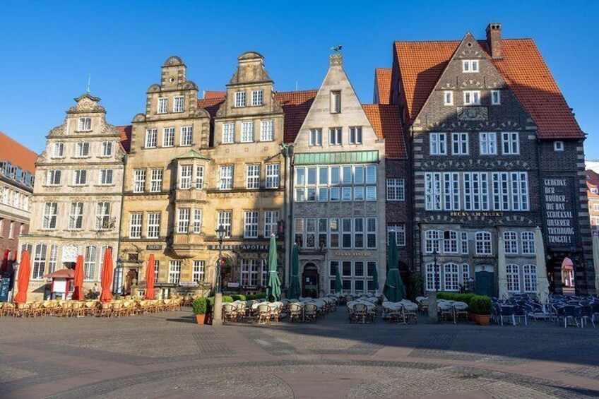 A row of historic buildings with red-tiled roofs and traditional architecture. 5
