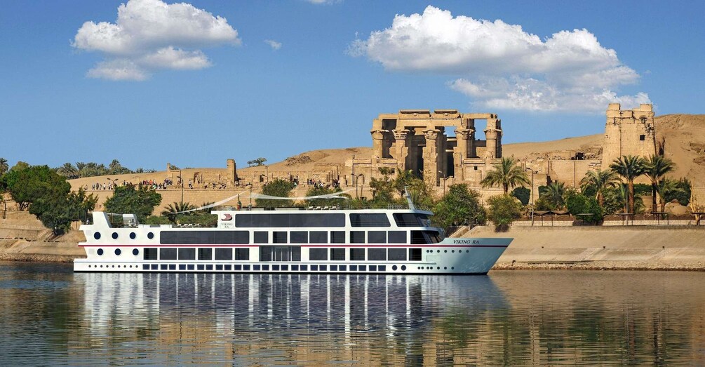 A Viking Ra river cruise boat on the Nile, with ancient Egyptian ruins in the background. 1