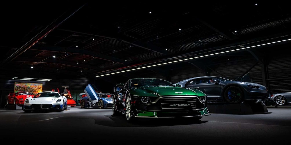 A car museum with various sports cars on display. 2