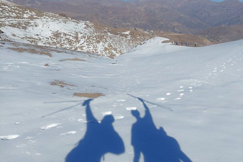 Eine verschneite Berglandschaft mit einer Skipiste und Skifahrern. 2