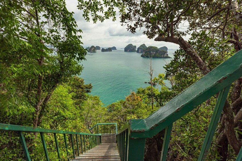 A staircase leading to a viewpoint overlooking a body of water with several islands. 3