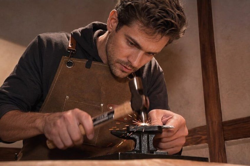A person working with a hammer and anvil. 1