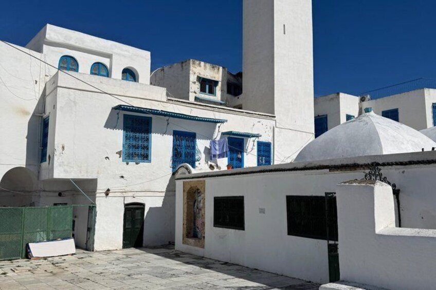 Un edificio bianco con finestre blu e una cupola bianca. 3