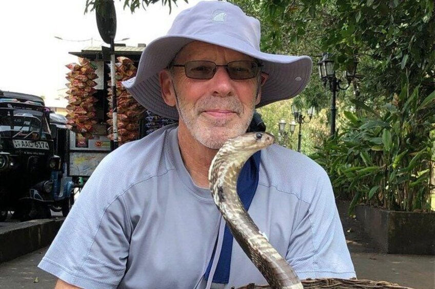 A person holding a snake. 4