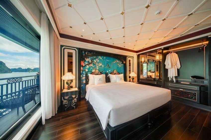 A bedroom with a large bed, a view of the sea, and a balcony. 4