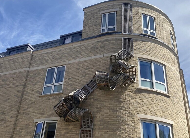 A building with a curved facade, multiple windows, and a spiral staircase. 2