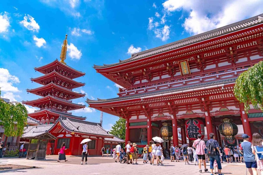 A traditional Japanese temple with a multi-tiered pagoda and red buildings. 1