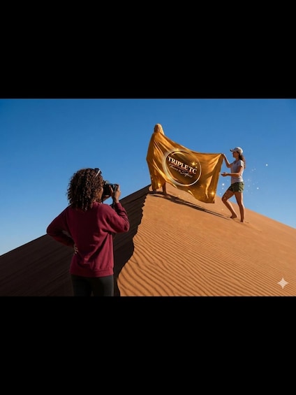 A person holding a golden banner with 'TRIPLE TC' text, standing on a sand dune. 1