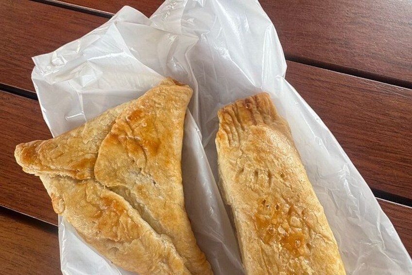 Two triangular pastries on a white paper. 3