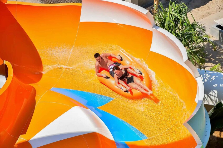 A water slide with a person and a child at the bottom. 4