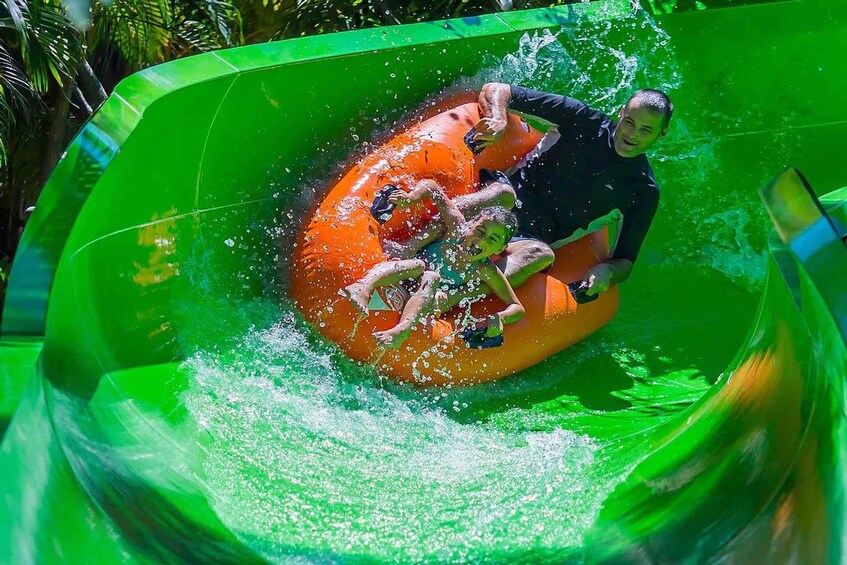 People in an inflatable tube on a water slide. 5