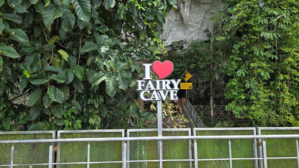 A sign with 'I love Fairy Cave' and a warning sign for Cliff Farm. 5