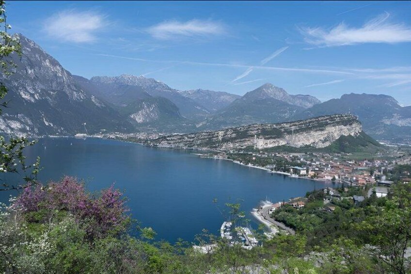 A lake surrounded by mountains, a town, and a fortified structure. 2