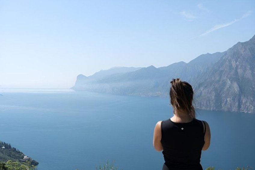A person overlooking a coastal landscape with mountains and a body of water. 5