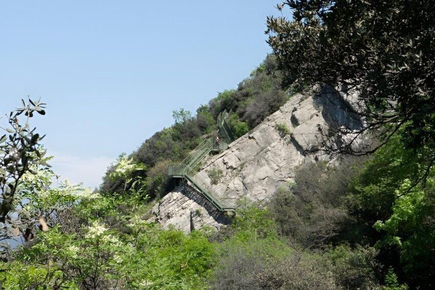 A rocky hillside with a metal staircase leading up. 4