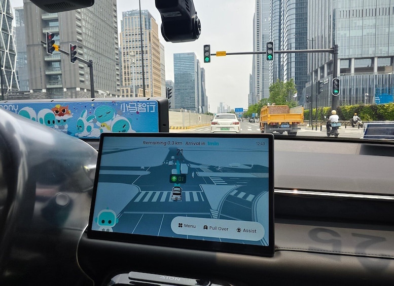 A car dashboard with a navigation screen displaying a route, traffic lights, and city buildings. 3