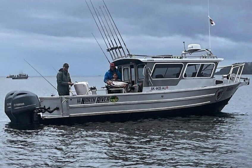 A boat named 'North River' with a Yamaha outboard motor, docked in calm waters. 1
