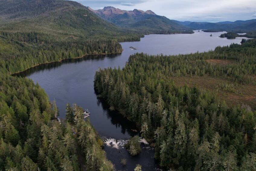 A lake surrounded by dense forest and mountains. 3