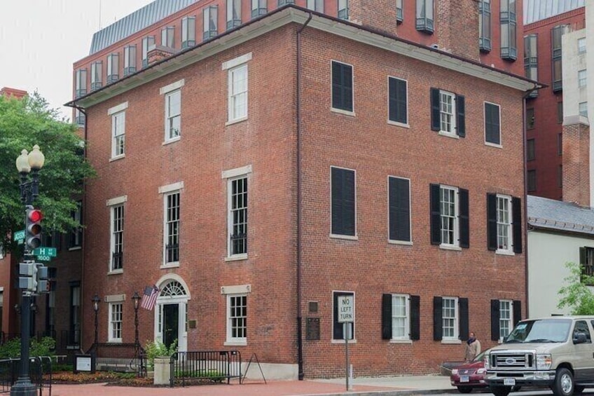 A red brick building with white trim, a street lamp, and a 'No Left Turn' sign. 5