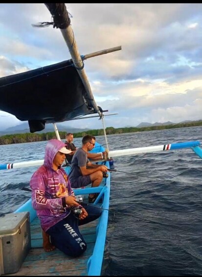 A boat with two people fishing, a mountainous landscape in the background, and a partly cloudy sky. 4