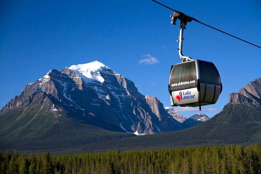 A cable car with the logo "Lake Louise" suspended above a mountainous landscape. 4