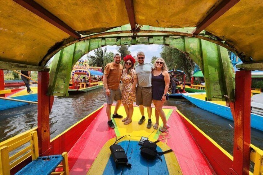 A colorful boat with a group of people standing on it. 2