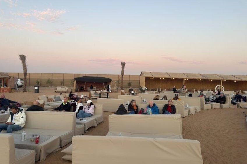 A desert resort with outdoor seating and palm trees. 2