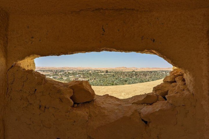 A cave opening with a view of a desert landscape. 3