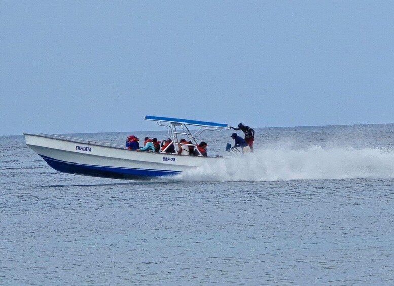 A speedboat with passengers and a wake behind it. 4