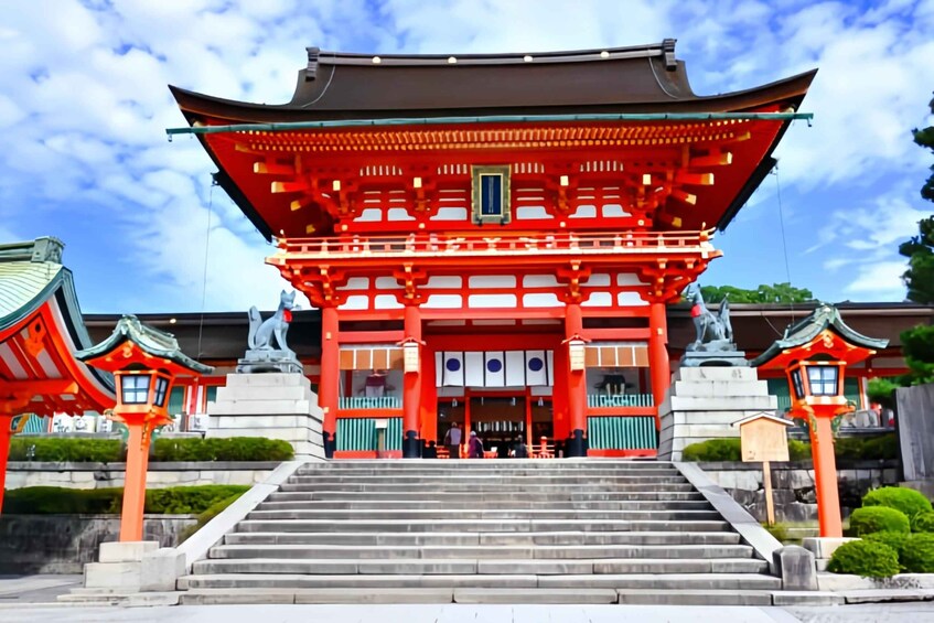 A traditional Japanese building with a red roof, white walls, and a central statue. 1